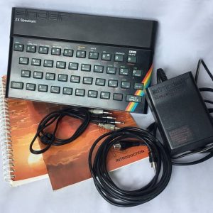 Complete refurbished Sinclair ZX Spectrum 48K set including cables, manuals, and Horizons software cassette.